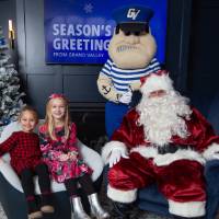 Two girls smile with Santa and Louie